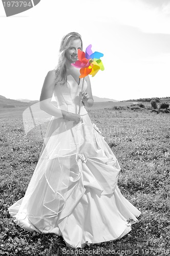 Image of beautiful bride outdoor with colorful windmill toy