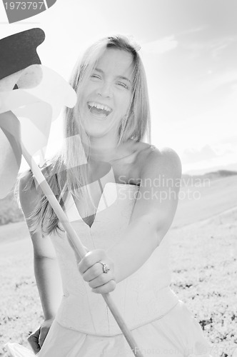 Image of beautiful bride outdoor with colorful windmill toy