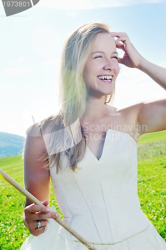 Image of beautiful bride outdoor with colorful windmill toy