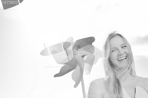 Image of beautiful bride outdoor with colorful windmill toy