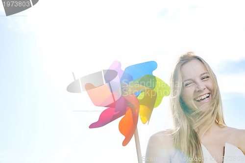 Image of beautiful bride outdoor with colorful windmill toy