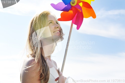 Image of beautiful bride outdoor with colorful windmill toy