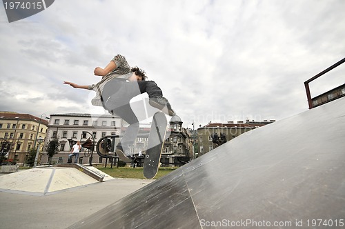 Image of Boy practicing skate in a skate park - isolated