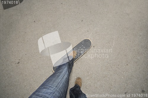 Image of Foot standing on skate board