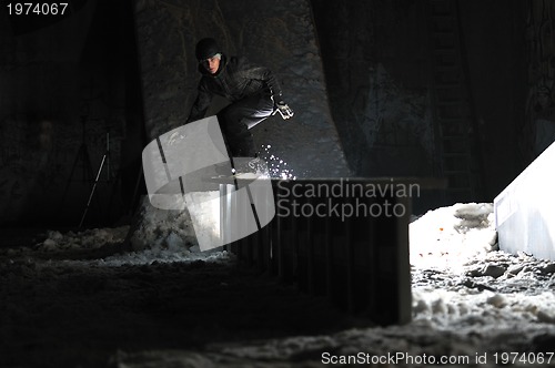 Image of freestyle snowboarder jump in air at night