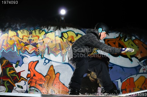 Image of freestyle snowboarder jump in air at night