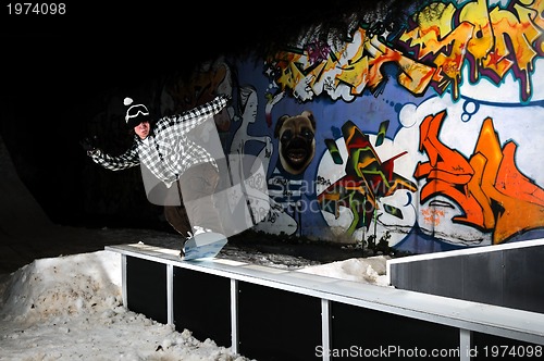 Image of freestyle snowboarder jump in air at night