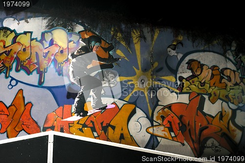 Image of freestyle snowboarder jump in air at night