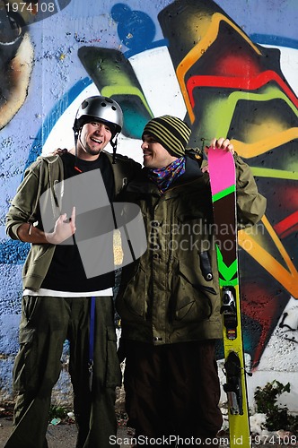 Image of two skiirs standing against colorful background