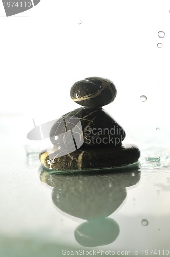 Image of isolated wet zen stones with splashing  water drops