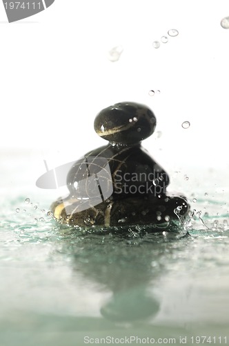 Image of isolated wet zen stones with splashing  water drops