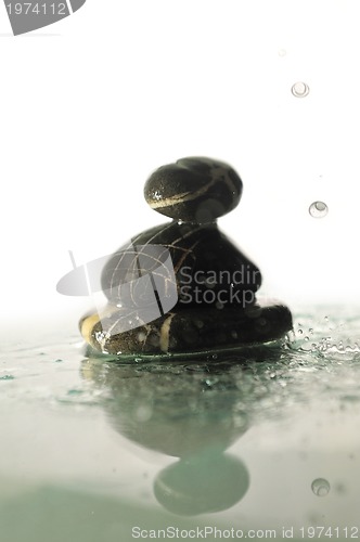 Image of isolated wet zen stones with splashing  water drops