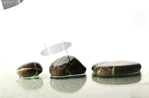 Image of isolated wet zen stones with splashing  water drops