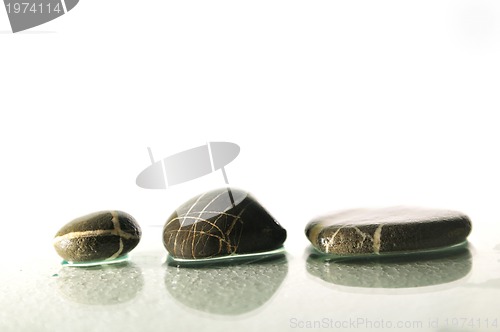 Image of isolated wet zen stones with splashing  water drops