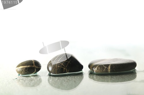 Image of isolated wet zen stones with splashing  water drops