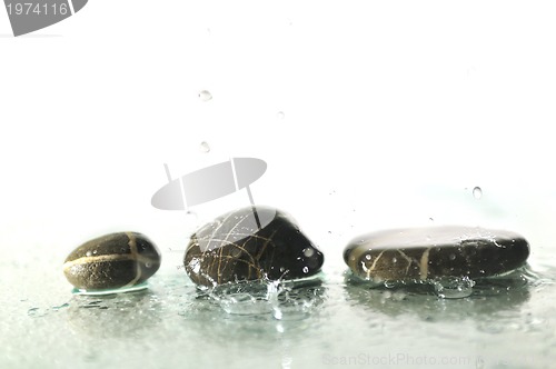 Image of isolated wet zen stones with splashing  water drops