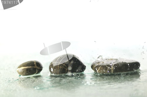 Image of isolated wet zen stones with splashing  water drops