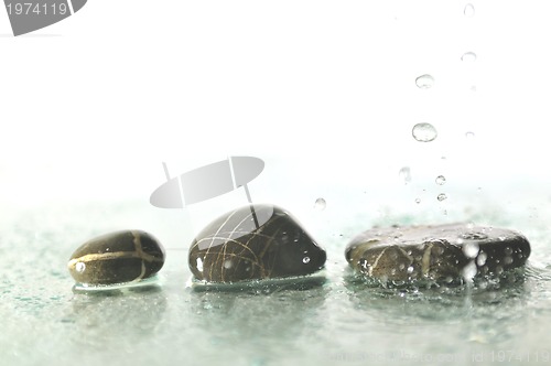 Image of isolated wet zen stones with splashing  water drops