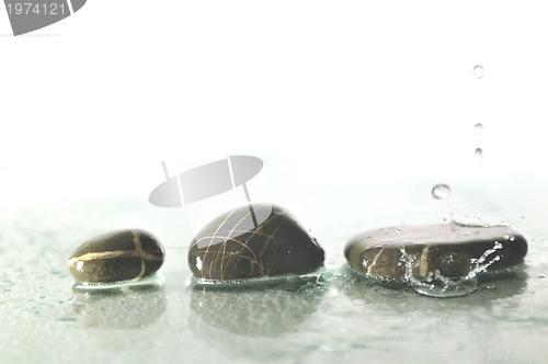 Image of isolated wet zen stones with splashing  water drops