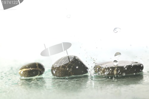 Image of isolated wet zen stones with splashing  water drops