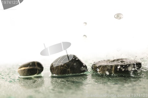 Image of isolated wet zen stones with splashing  water drops