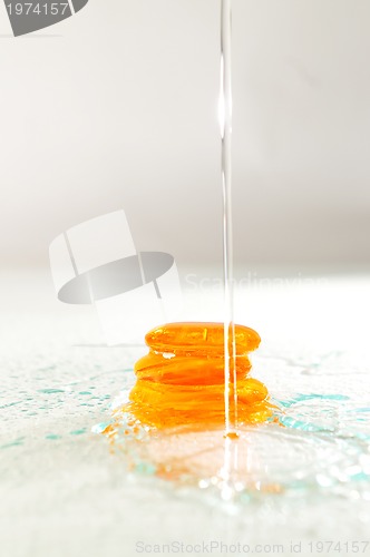 Image of isolated wet zen stones with splashing  water drops  