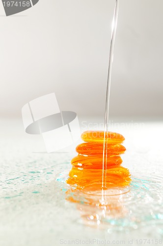 Image of isolated wet zen stones with splashing  water drops  