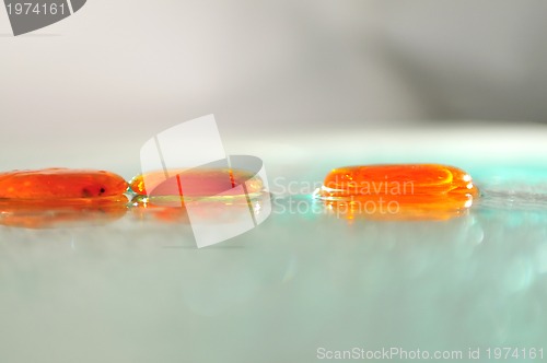 Image of isolated wet zen stones with splashing  water drops  