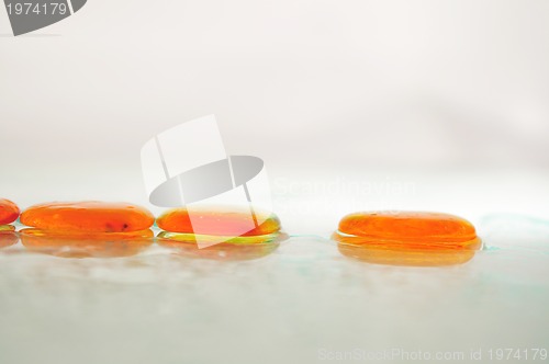 Image of isolated wet zen stones with splashing  water drops  