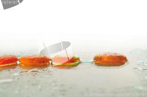 Image of isolated wet zen stones with splashing  water drops  