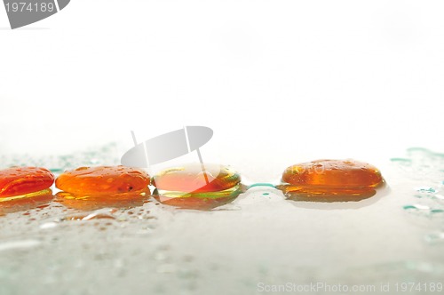 Image of isolated wet zen stones with splashing  water drops  