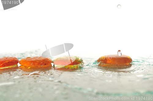 Image of isolated wet zen stones with splashing  water drops  