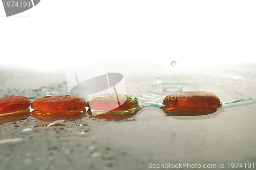 Image of isolated wet zen stones with splashing  water drops  