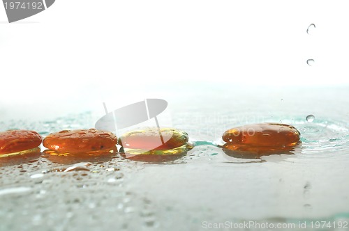 Image of isolated wet zen stones with splashing  water drops