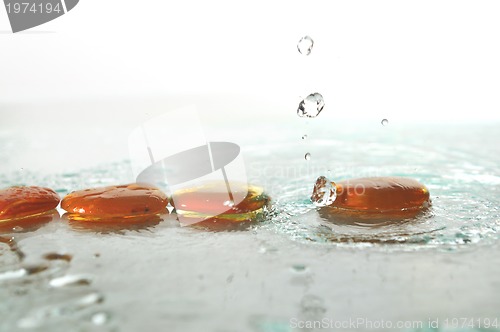 Image of isolated wet zen stones with splashing  water drops