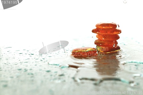 Image of isolated wet zen stones with splashing  water drops