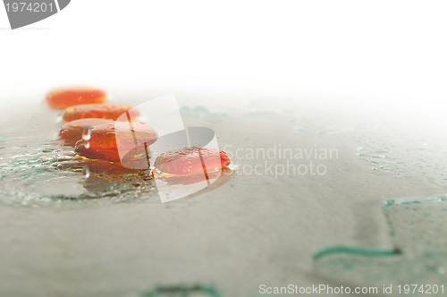 Image of isolated wet zen stones with splashing  water drops  