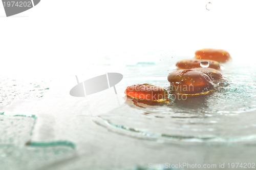 Image of isolated wet zen stones with splashing  water drops