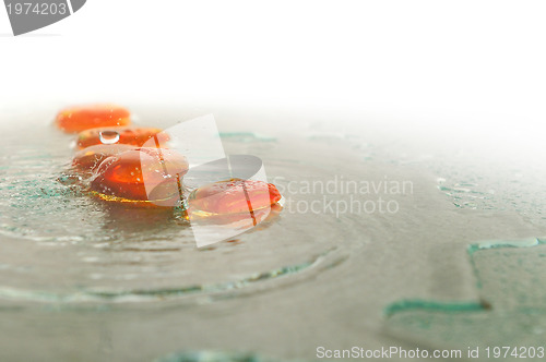 Image of isolated wet zen stones with splashing  water drops  