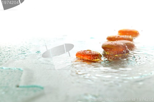 Image of isolated wet zen stones with splashing  water drops