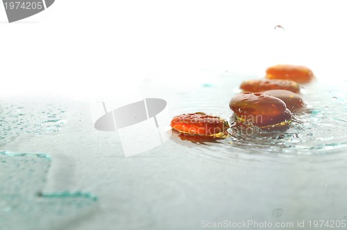 Image of isolated wet zen stones with splashing  water drops