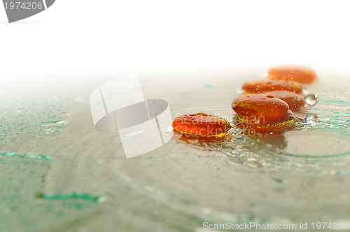 Image of isolated wet zen stones with splashing  water drops  