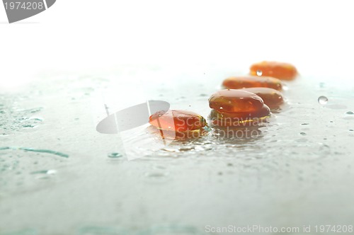 Image of isolated wet zen stones with splashing  water drops