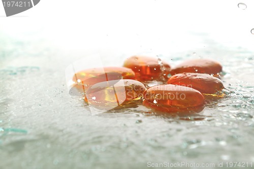 Image of isolated wet zen stones with splashing  water drops