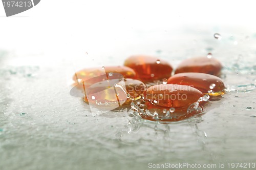 Image of isolated wet zen stones with splashing  water drops