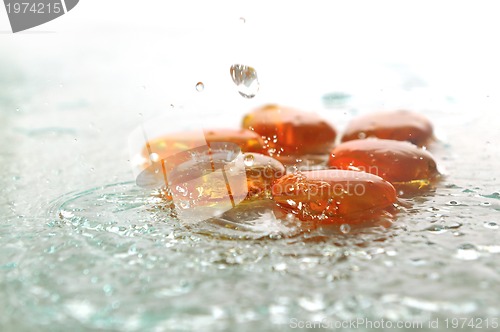 Image of isolated wet zen stones with splashing  water drops