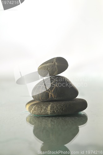 Image of isolated wet zen stones with splashing  water drops