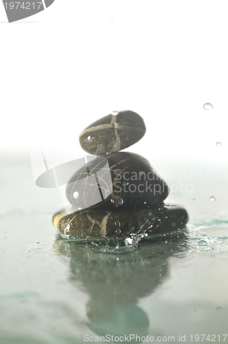 Image of isolated wet zen stones with splashing  water drops