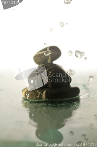 Image of isolated wet zen stones with splashing  water drops