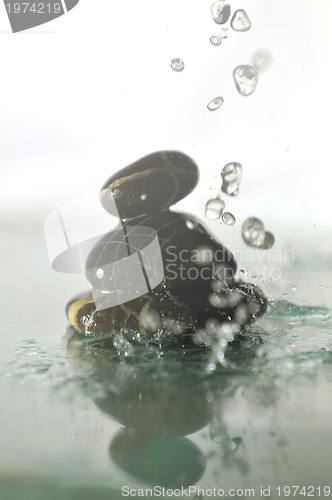 Image of isolated wet zen stones with splashing  water drops